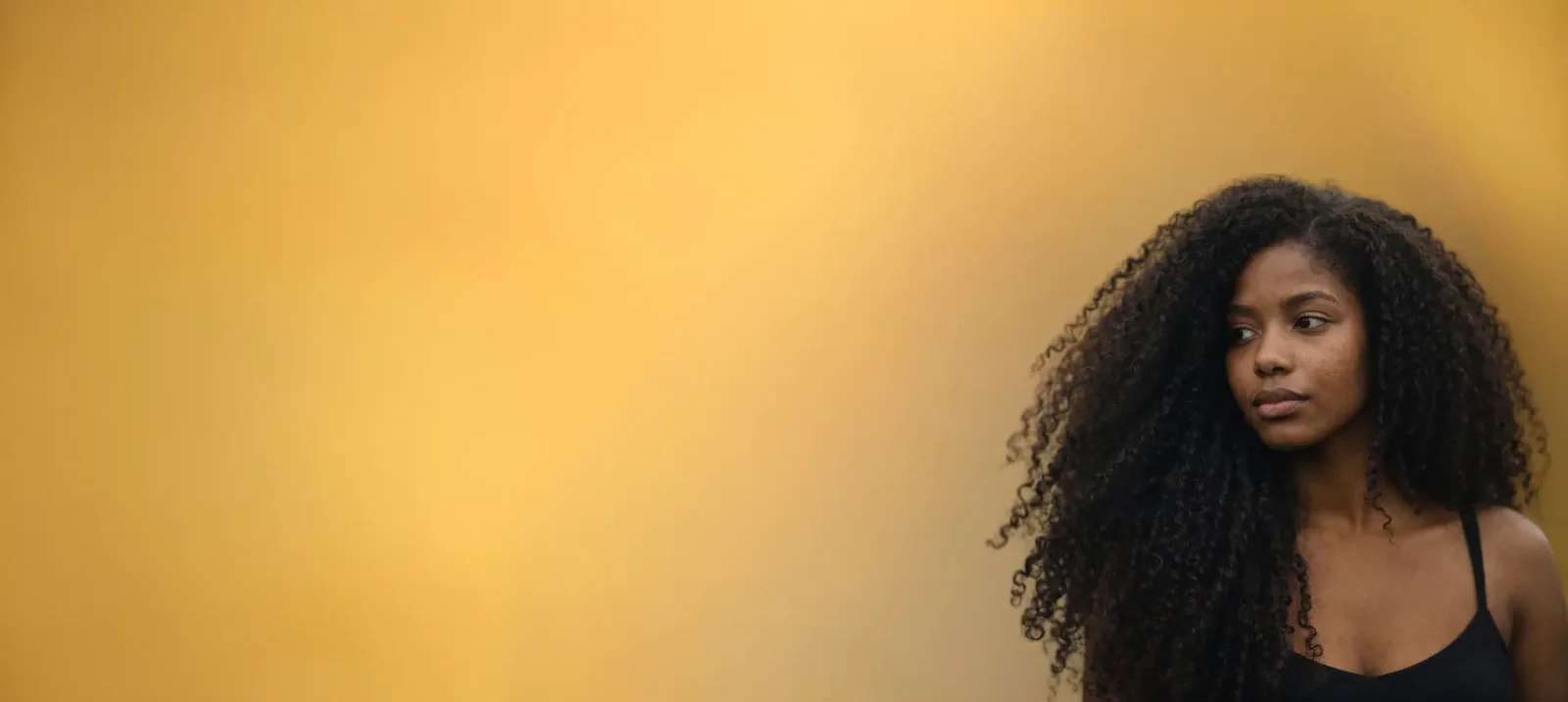Woman with long natural curly Indian human hair